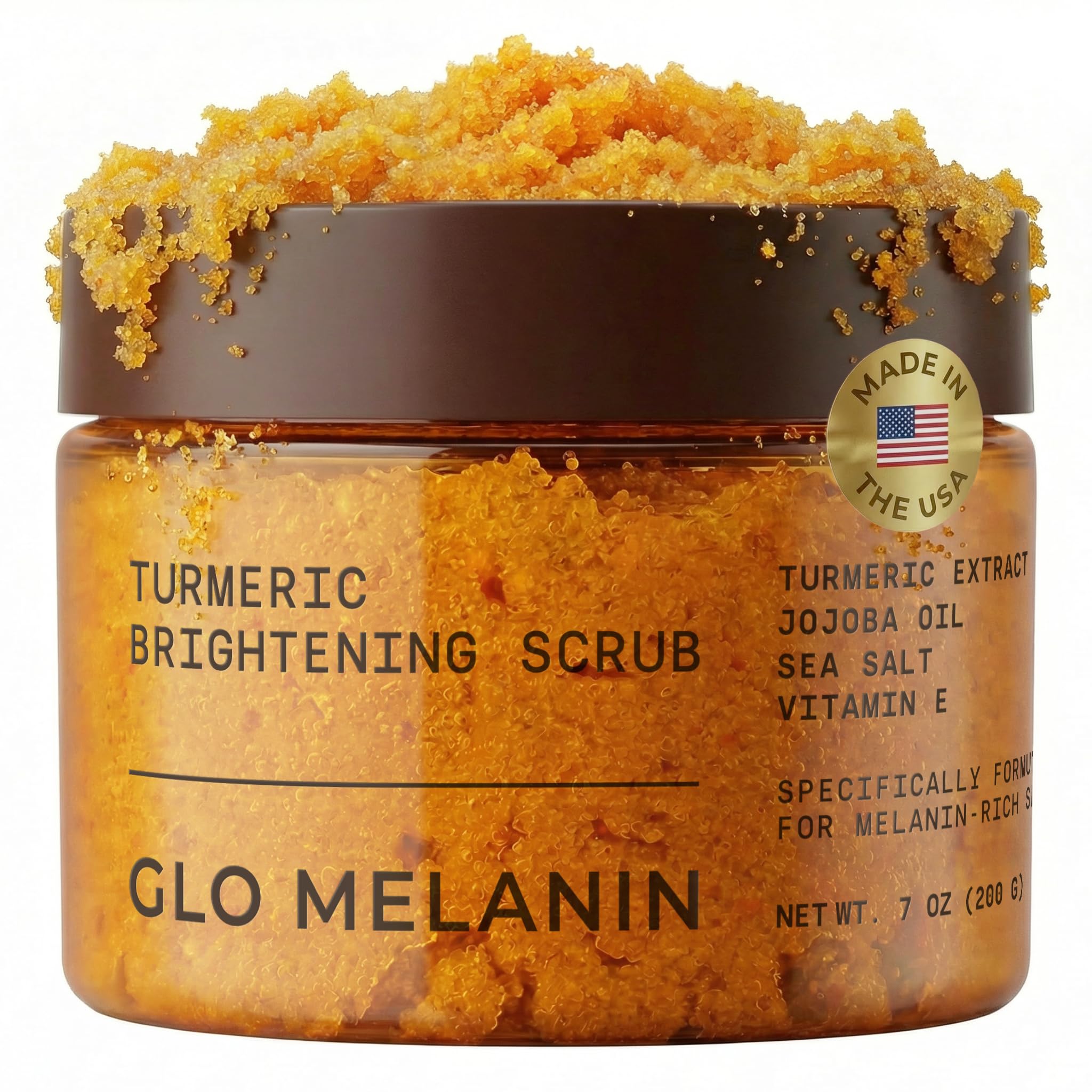 Glo Melanin turmeric scrub bottle close-up for natural exfoliation and radiant skin.