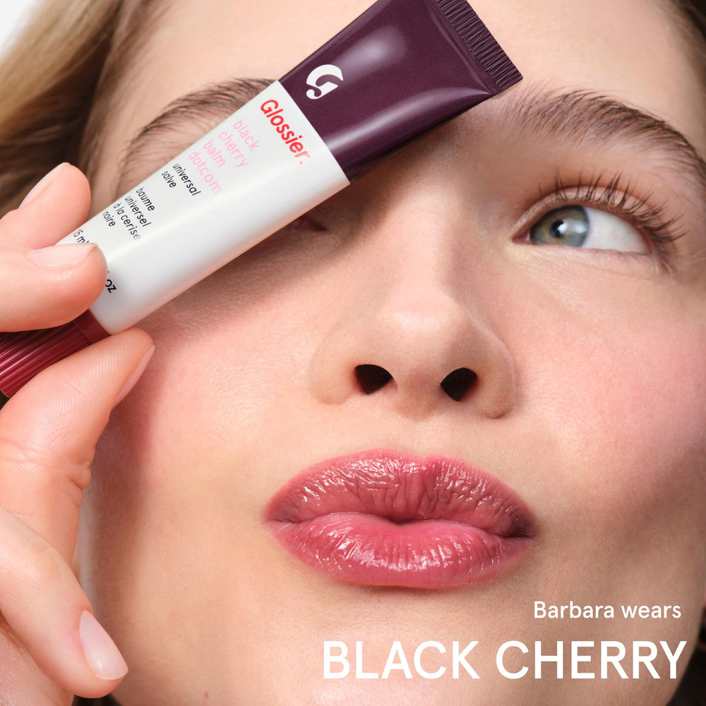 Glossier Balm Dotcom soft sheen on lips with non-sticky feel.