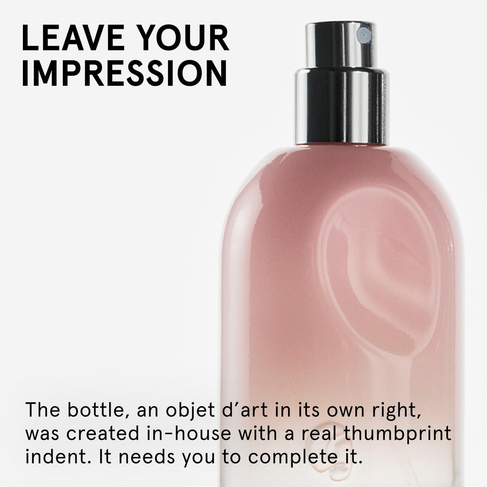 Glossier You cap detail on a sleek bottle with soft finish.