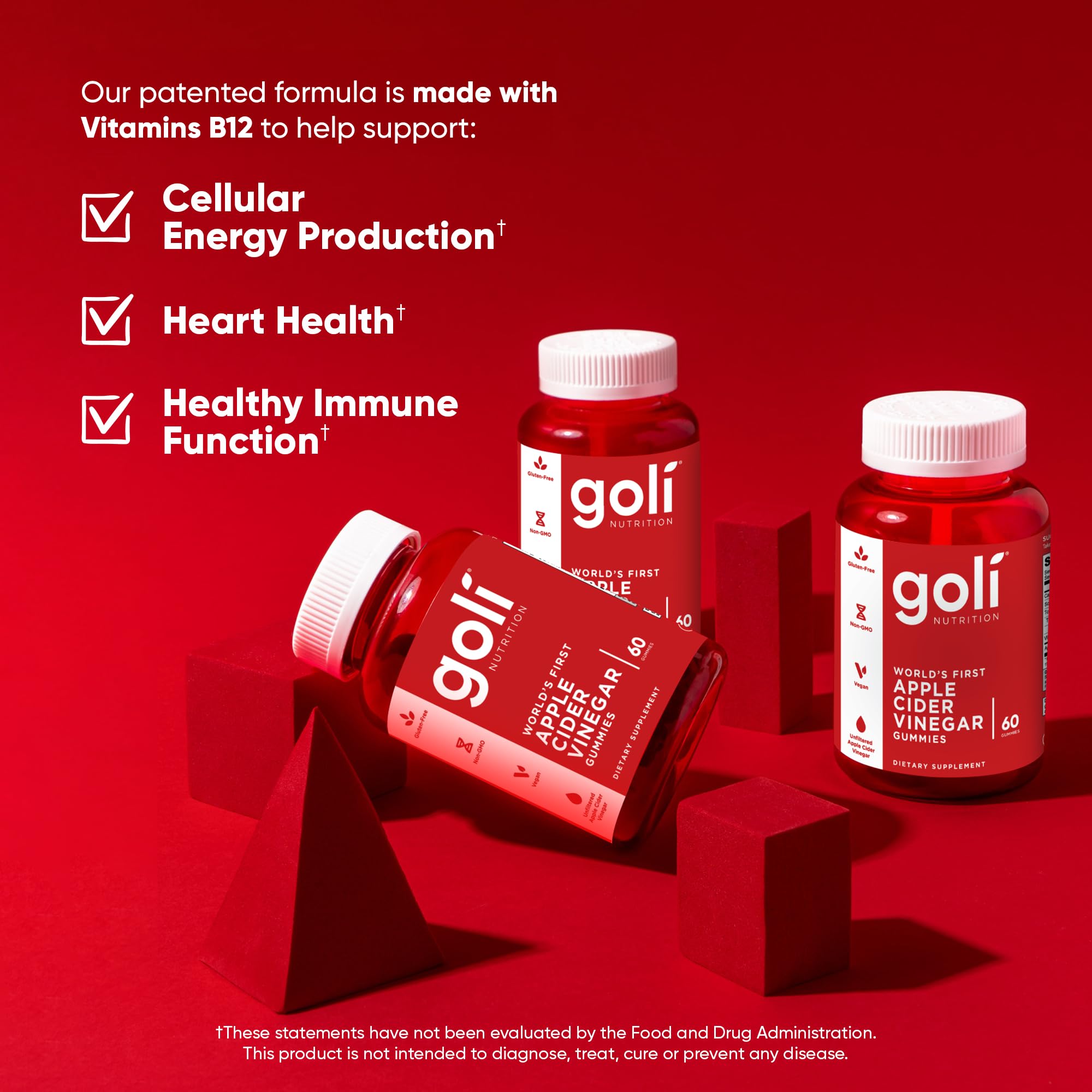 Goli gummies on a desk with workout gear suggest daily wellness routine