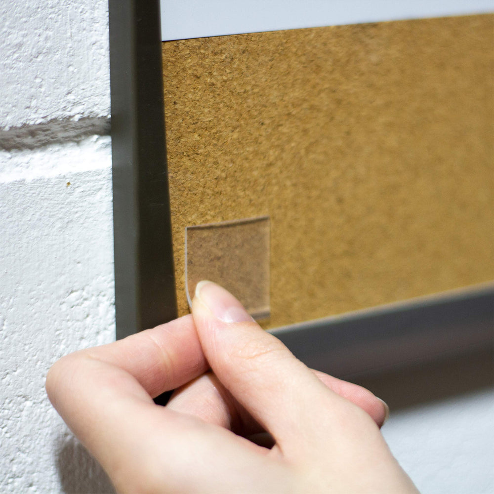 Gorilla clear tape squares disappear behind items for clean mounting