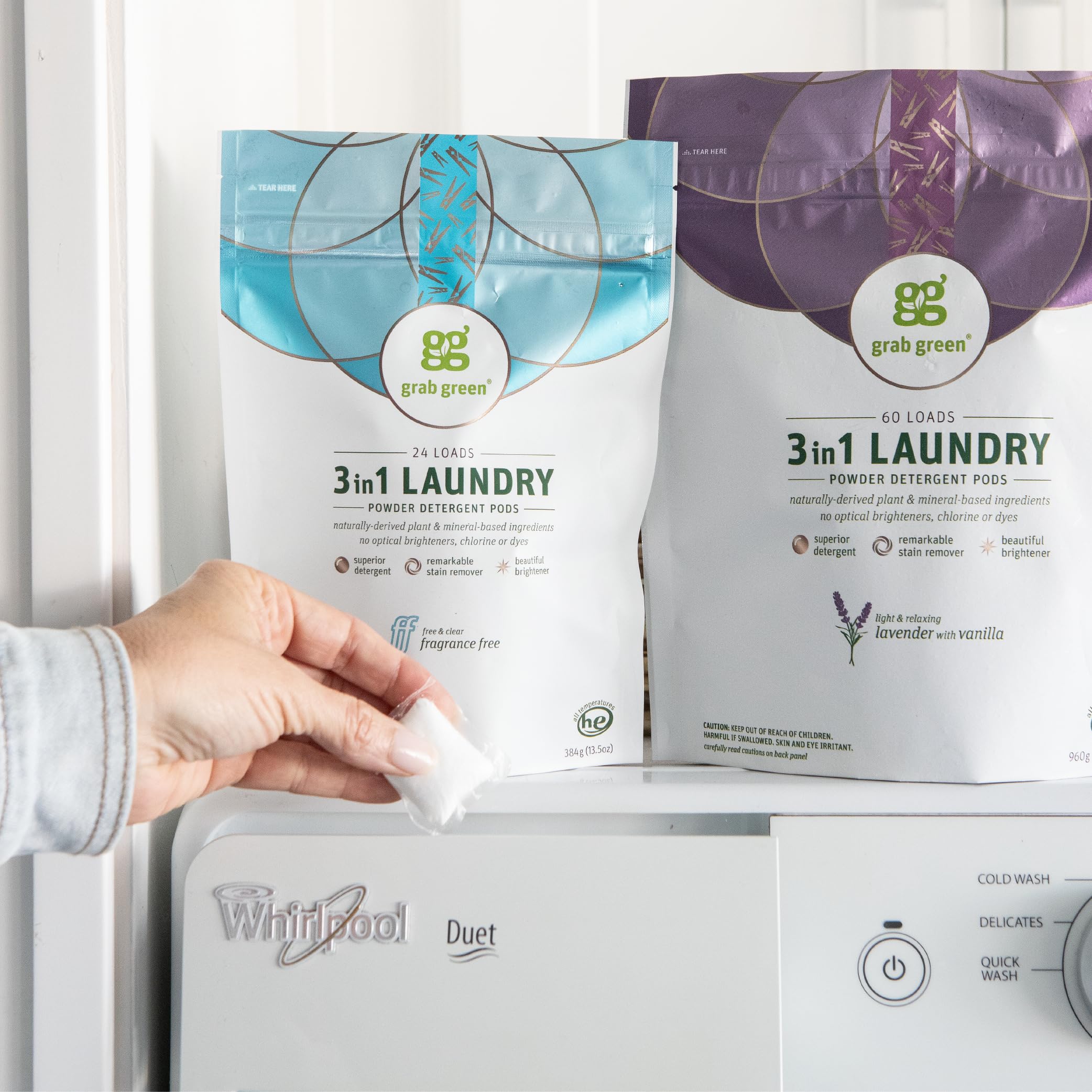Laundry scene with Grab Green pods ready to use in a washer