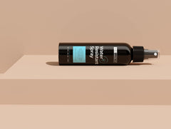 Hair Illusion model applying spray on wet hair for quick refresh.
