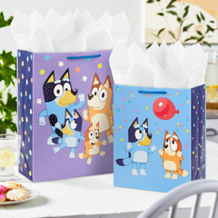 Hallmark Bluey gift bag with dancing Bluey family under purple stars, great for celebrations.