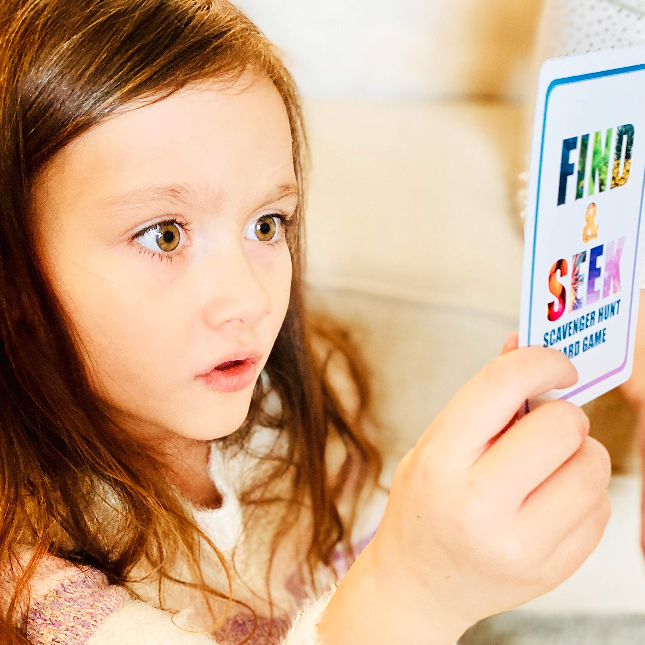 Kids enjoying a road trip activity with Hapinest Find and Seek scavenger cards.