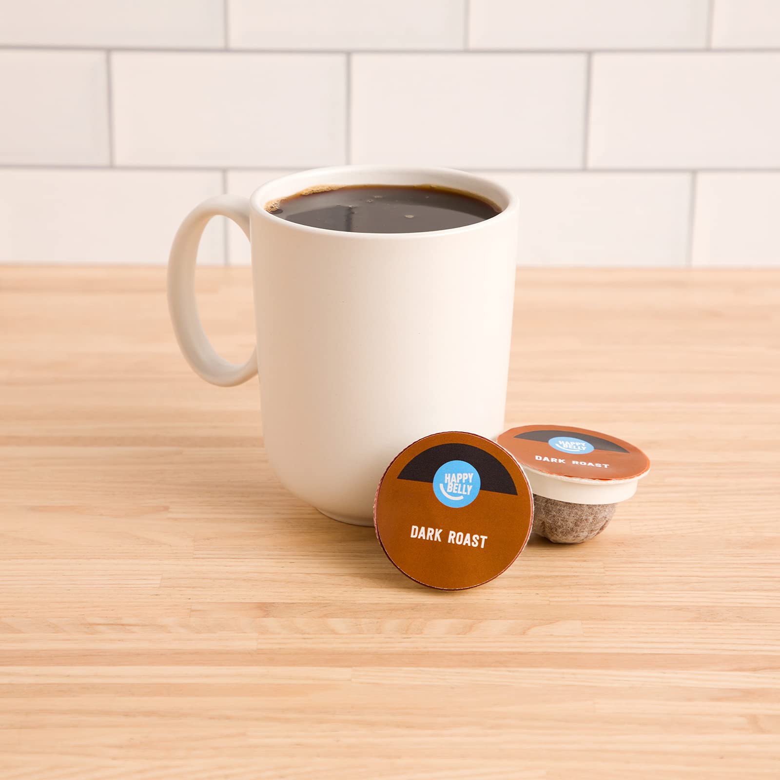 Close-up of Happy Belly Dark Roast pod highlighting 100% Arabica beans.