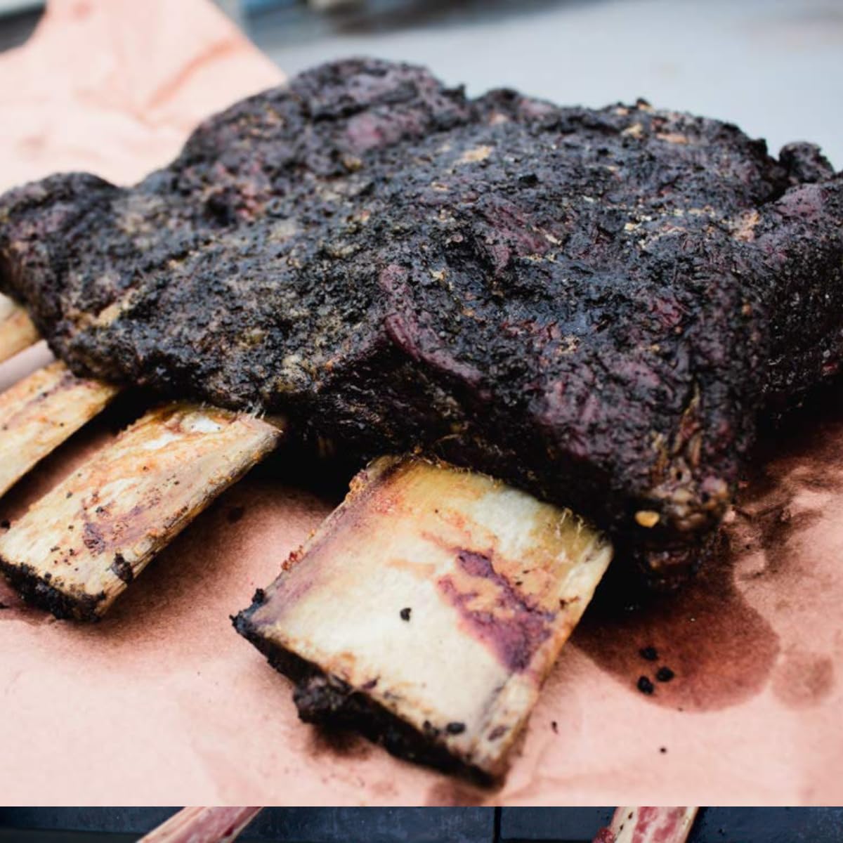 Hardcore Carnivore Black brisket smoking scene emphasizing deep bark and savory smoke.