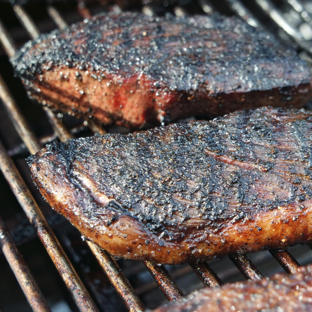 Hardcore Carnivore Black burger searing close-up for juicy patty with crust.