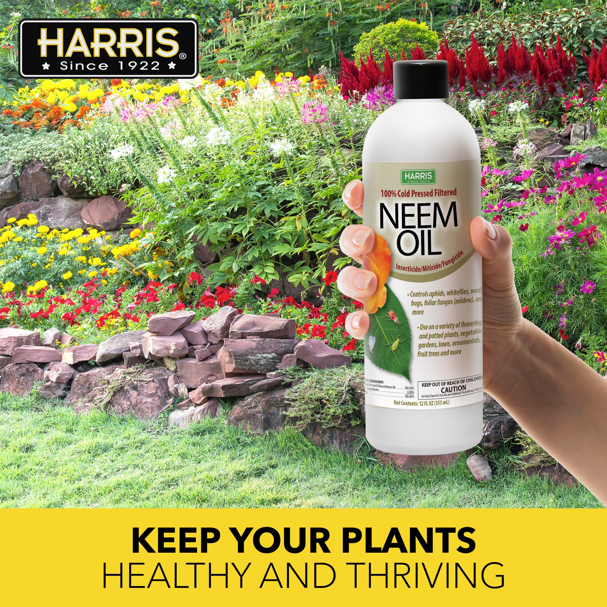 Harris neem oil bottle in an outdoor garden setting for pest control.