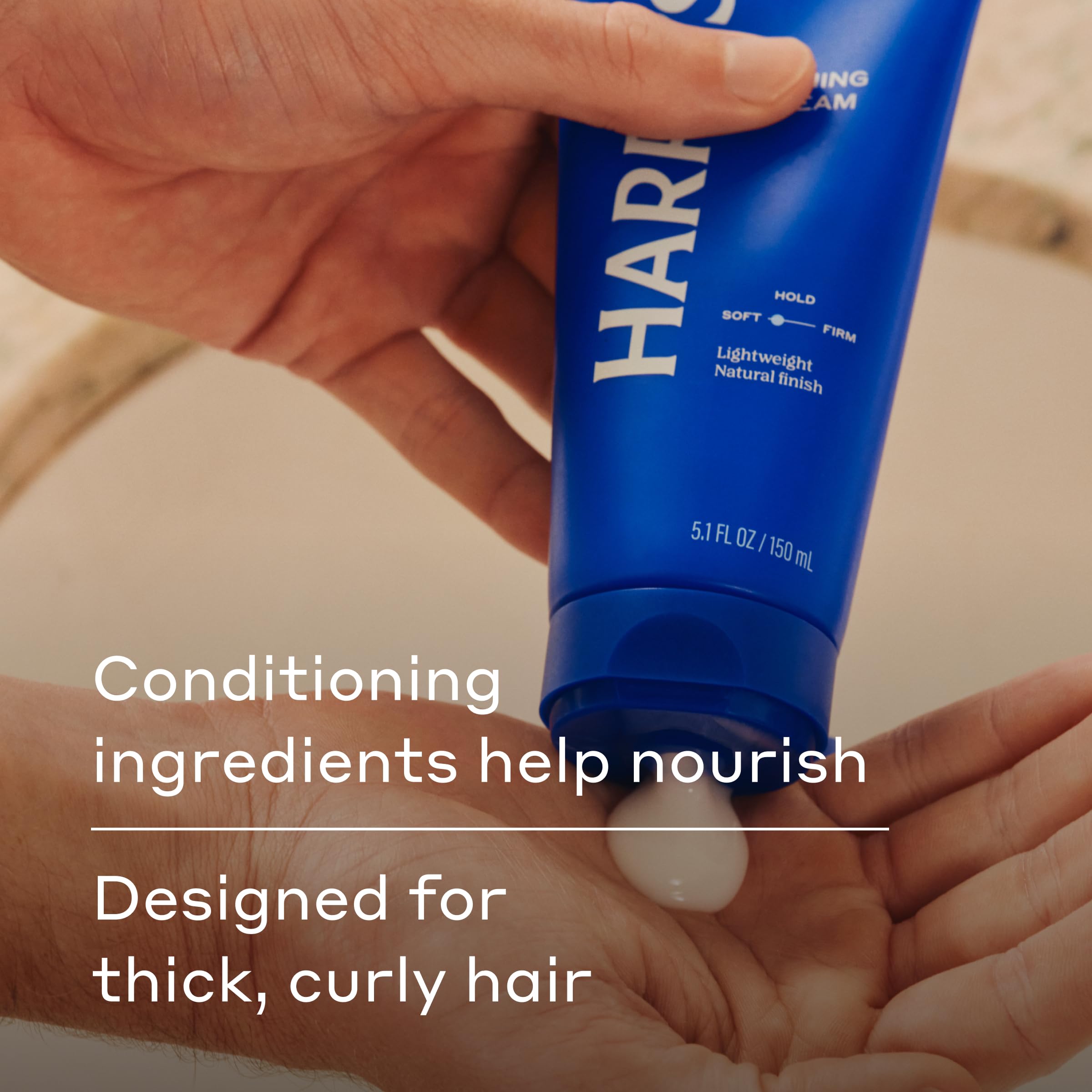 Applying Harry's Hair Taming Cream to damp hair for smooth control.