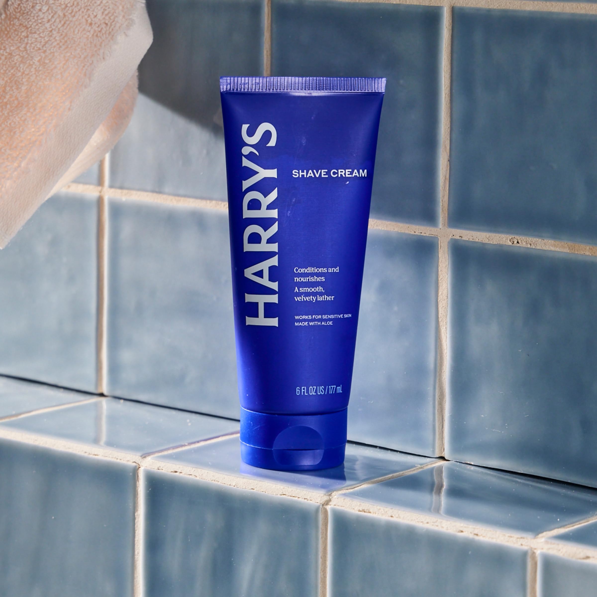 Close-up of Harry's shave cream massaged onto wet skin for cooling feel.