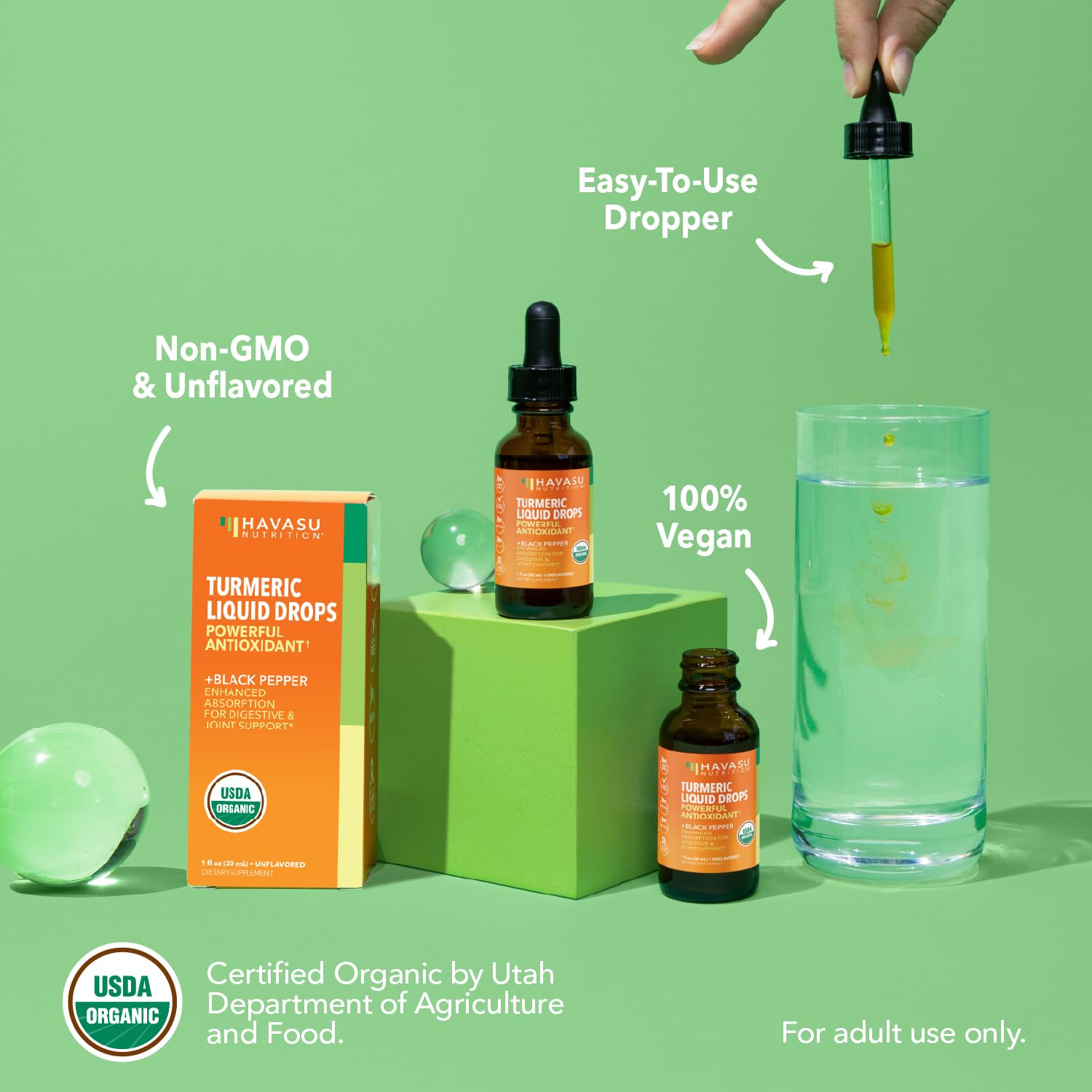 Havasu Nutrition Turmeric Drops bottle with glass of water for on-the-go routine.