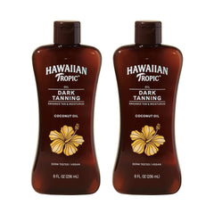 Hawaiian Tropic Dark Tanning Oil bottle on sandy beach for hydration