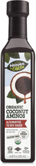 HEAVEN & EARTH Coconut Aminos bottle on a kitchen counter, soy-free and paleo-friendly.