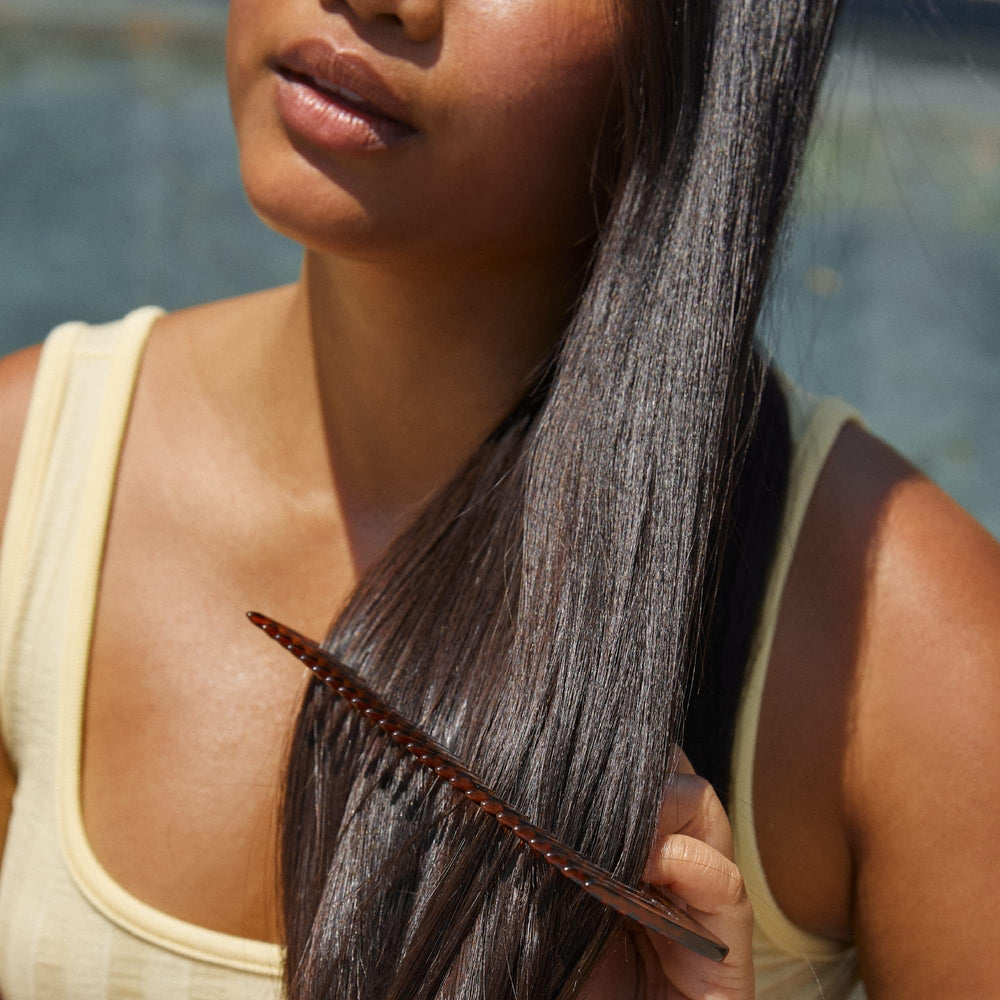 Hers Biotin Saw Palmetto oil pump bottle spotlights nourishing scalp support and subtle voluminous effect.