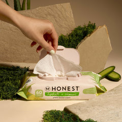 The Honest Company Hydrate and Cleanse wipes in car front seat for on-the-go freshening.