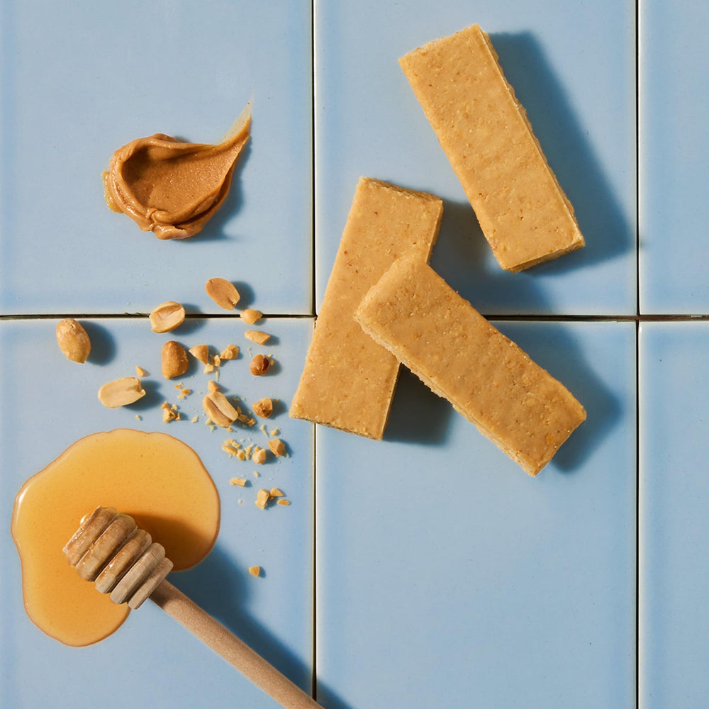 Bar on wooden surface emphasizes premium, low-ingredients snack option.