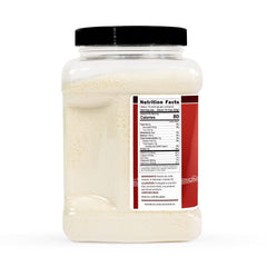 Pouring Hoosier Hill Farm instant nonfat milk powder into a glass for a creamy drink.