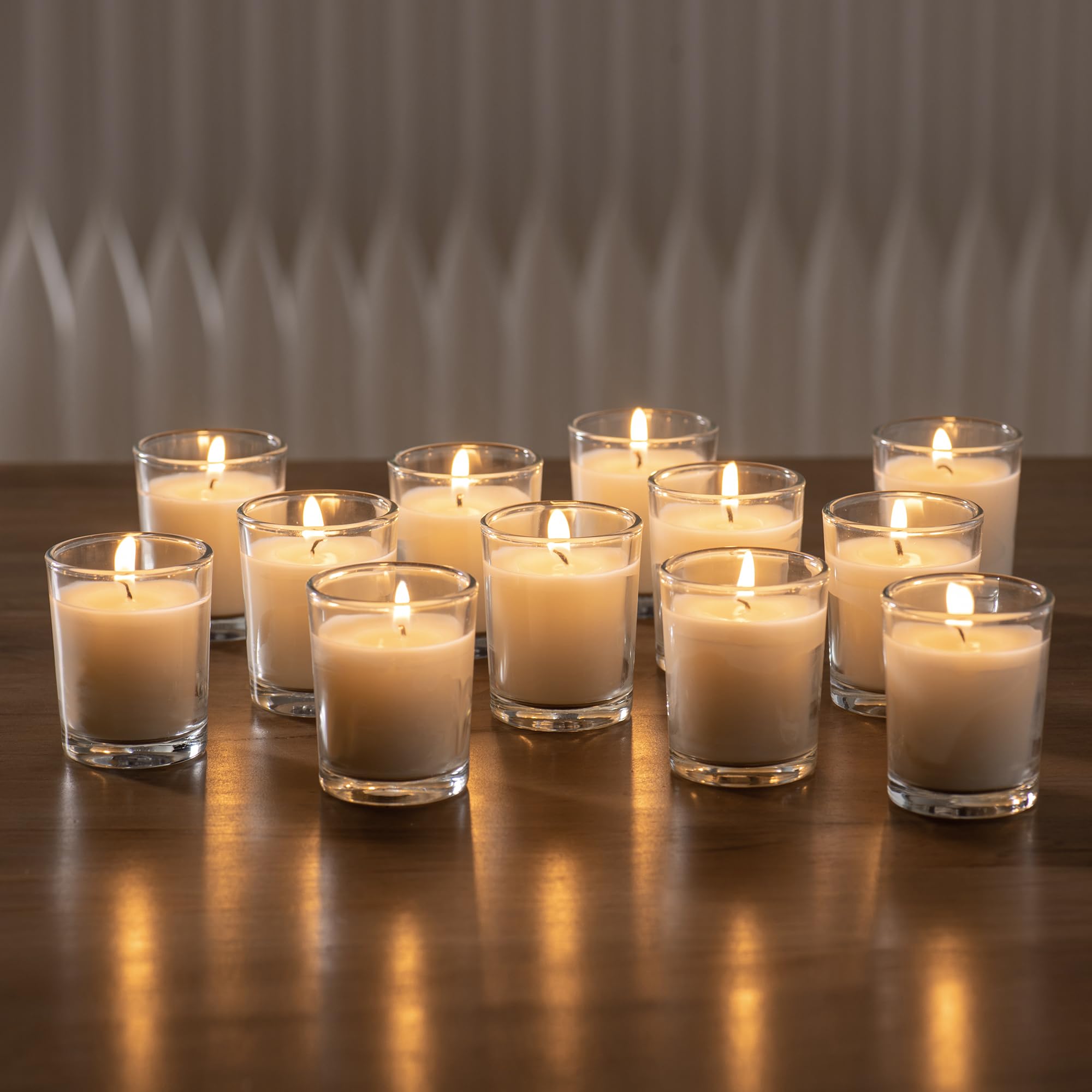 Housecret warm white unscented glass votives with 8–12 hour burn time.