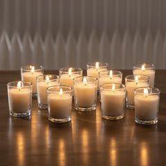 Housecret warm white unscented glass votives with 8–12 hour burn time.