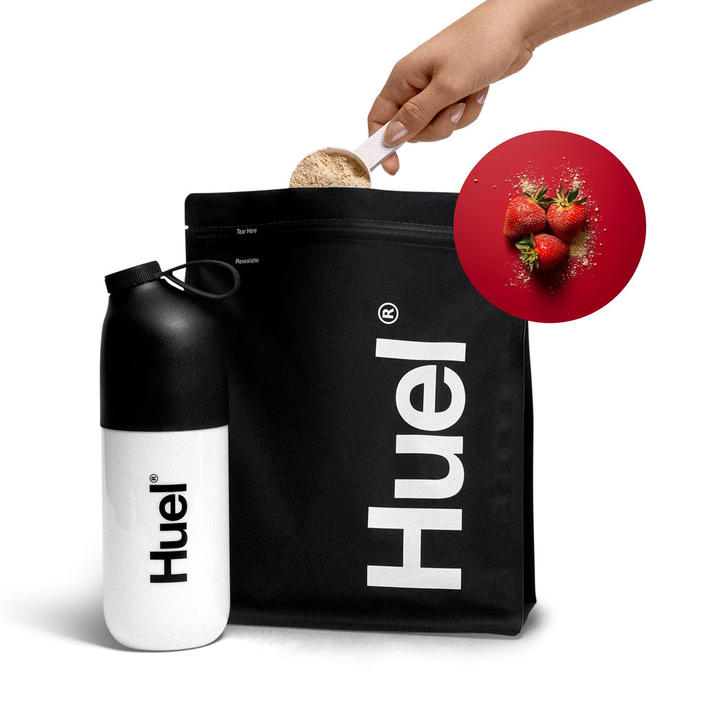 Huel Black Edition Strawberry meal replacement in a to-go cup for travel