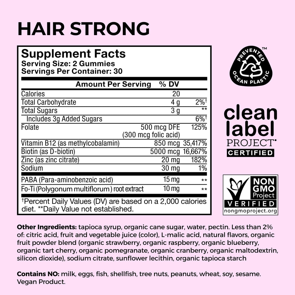 HUM Hair Strong bottle with bright strawberry color signals lifestyle-friendly hair care