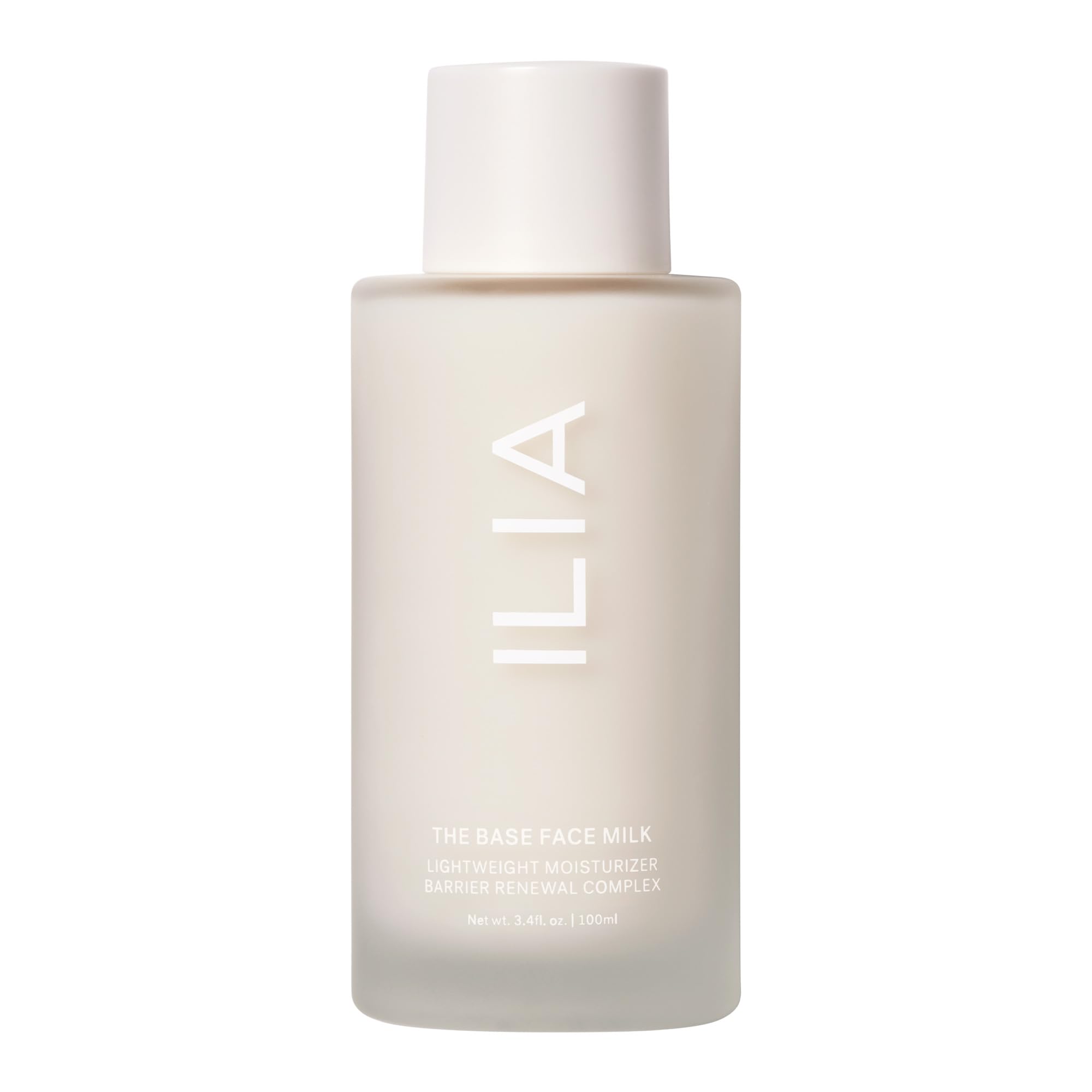 ILIA The Base Face Milk Essence bottle on a vanity showing vegan packaging and clean branding for hydration.