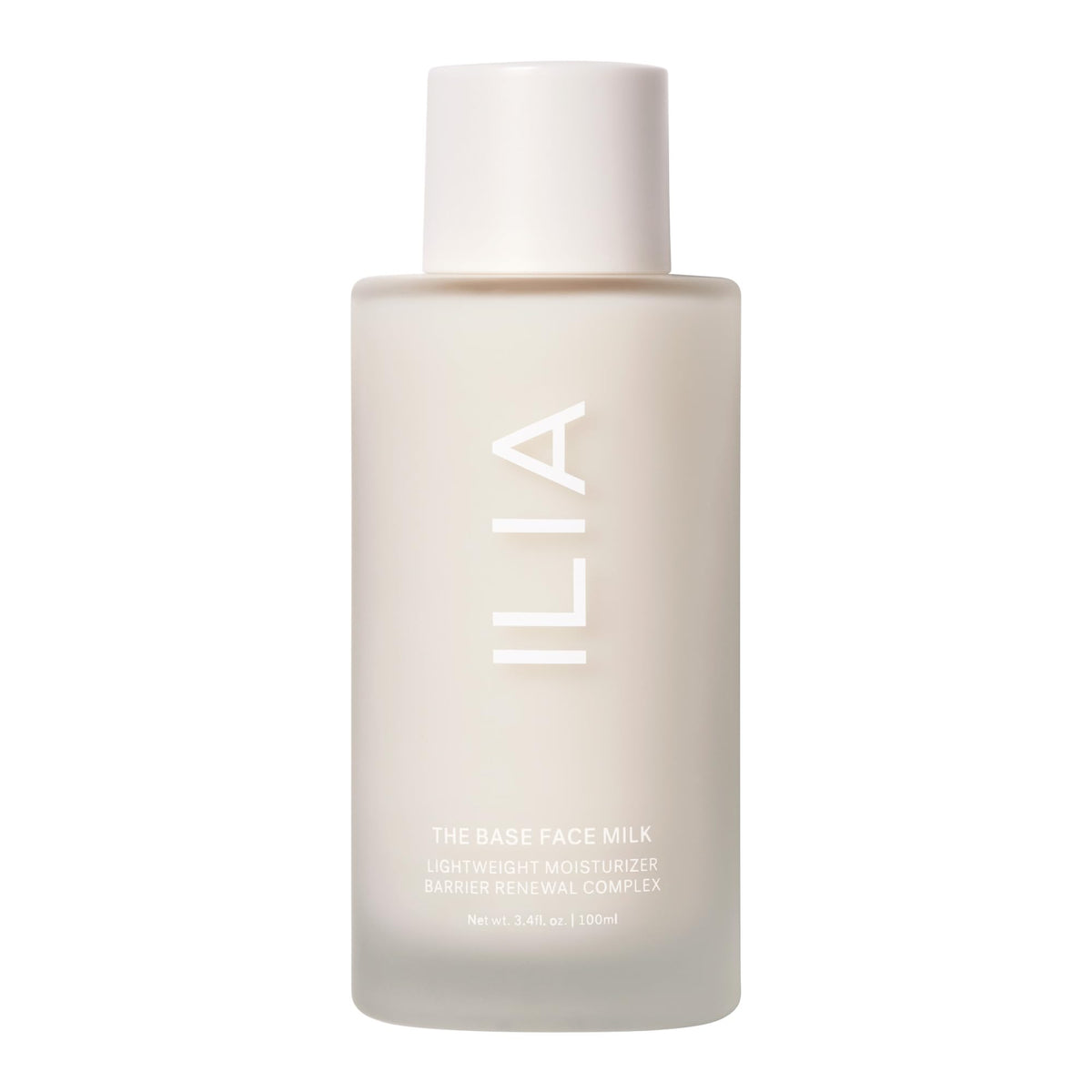 ILIA The Base Face Milk Essence bottle on a vanity showing vegan packaging and clean branding for hydration.