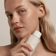 Close-up of ILIA The Base Face Milk Essence ingredients featuring microalgae for nourishment.