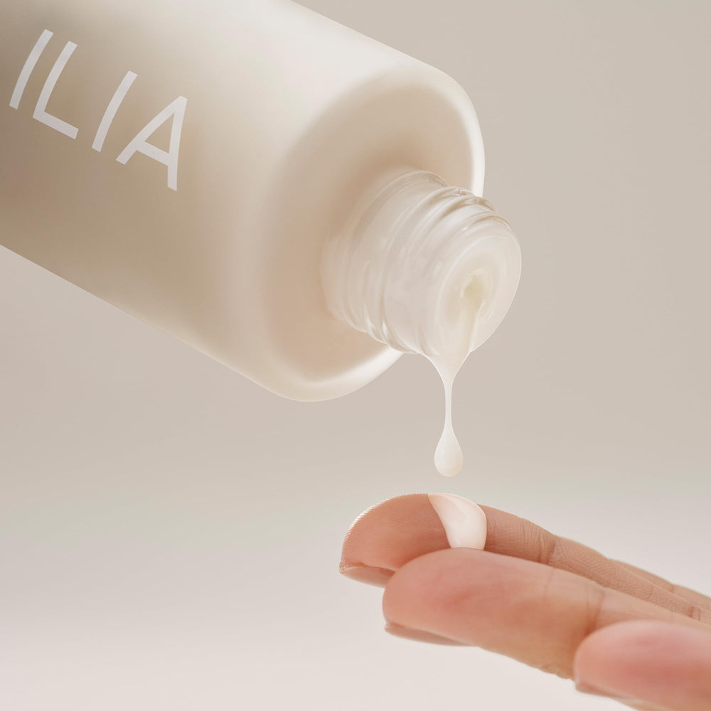 Pump-dispense cap of ILIA The Base Face Milk Essence for precise dosing.