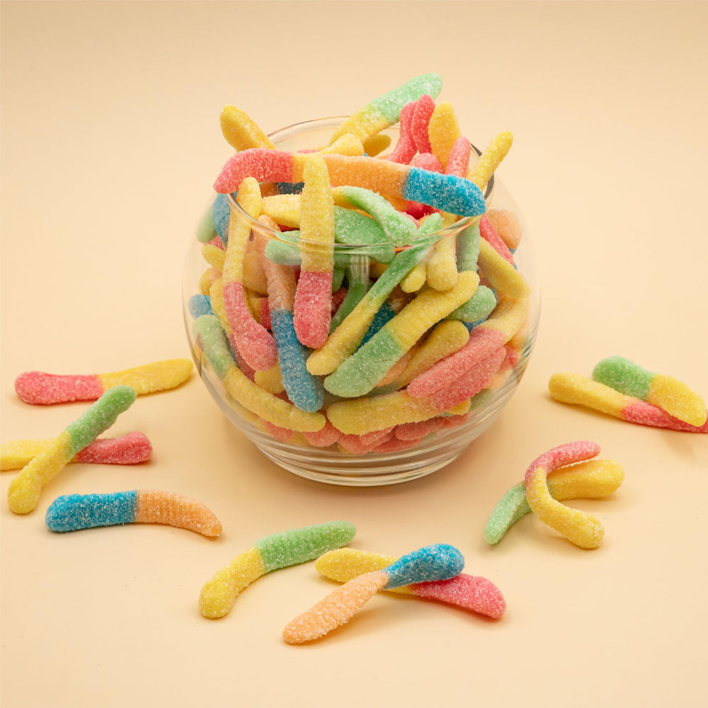 ILIKE! Neon Sour Gummy Worms Easter display table with colorful candy options.