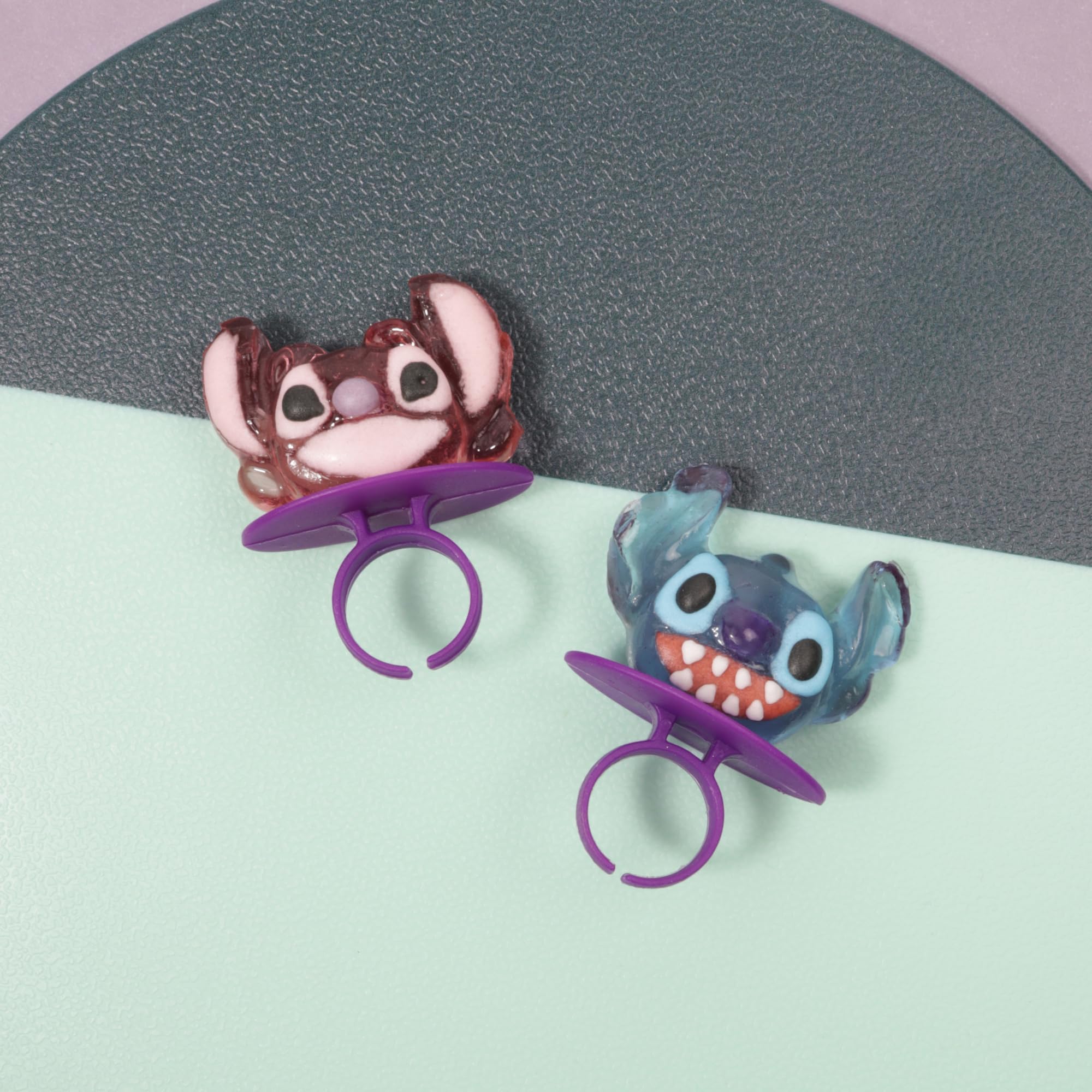 Imaginings3 Stitch strawberry lollipop ring adds playful charm to treats.