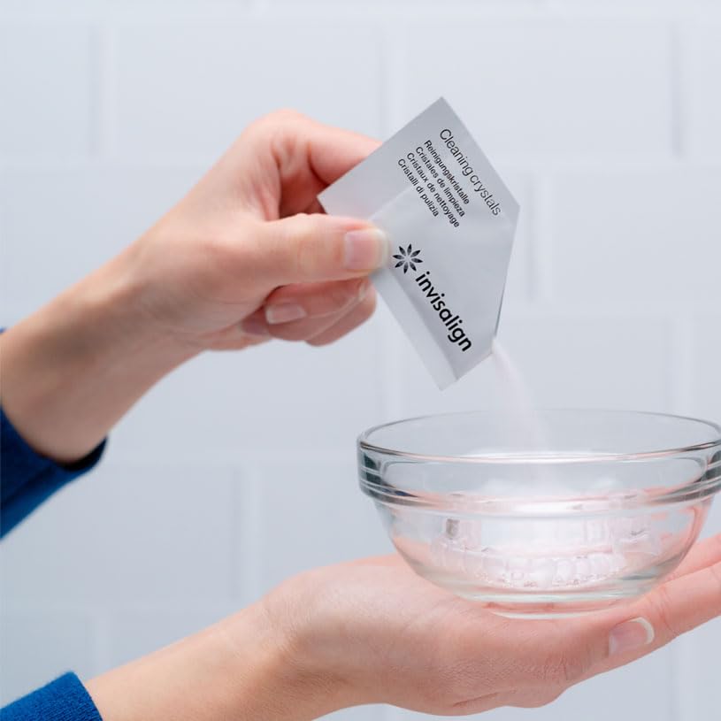 Invisalign Cleaning Crystals in container with aligners ready for use.