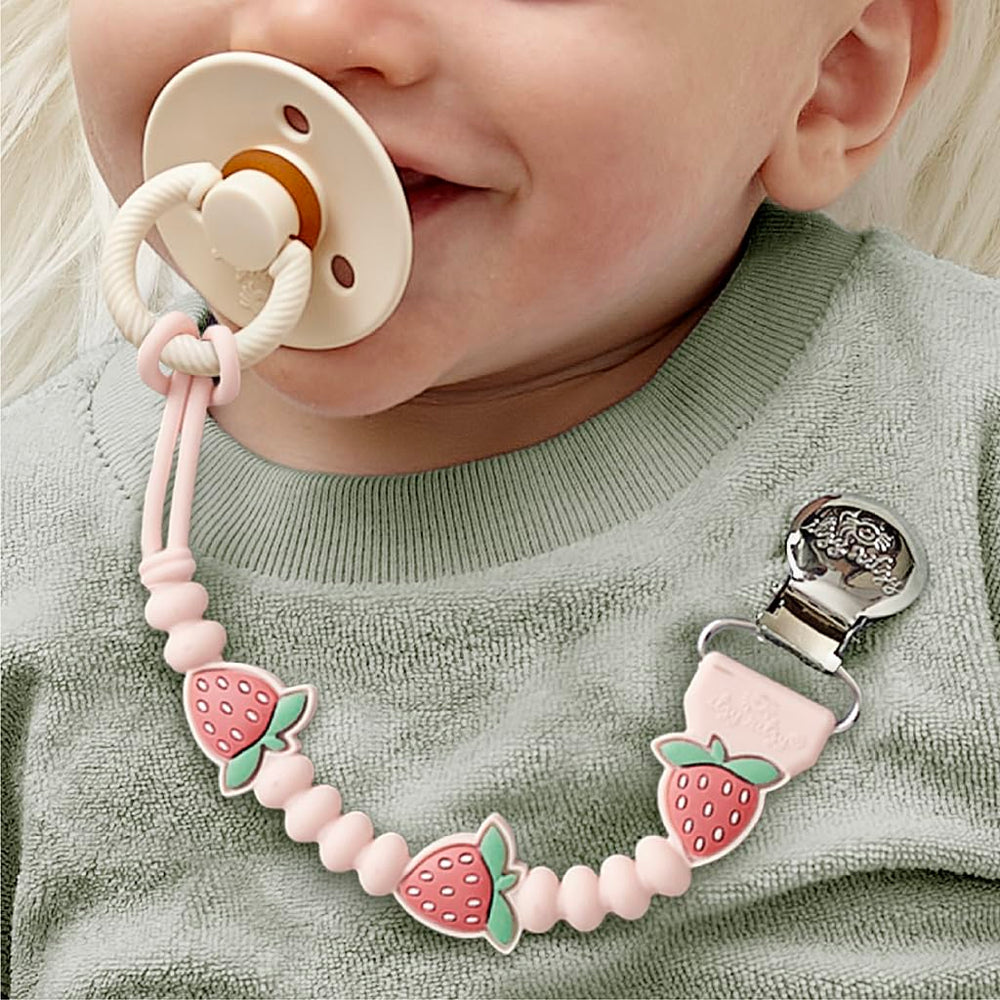 Itzy Ritzy pacifier clip close-up with strawberry character