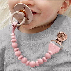 Close-up of Itzy Ritzy pacifier clip secure clasp prevents loss without snagging.