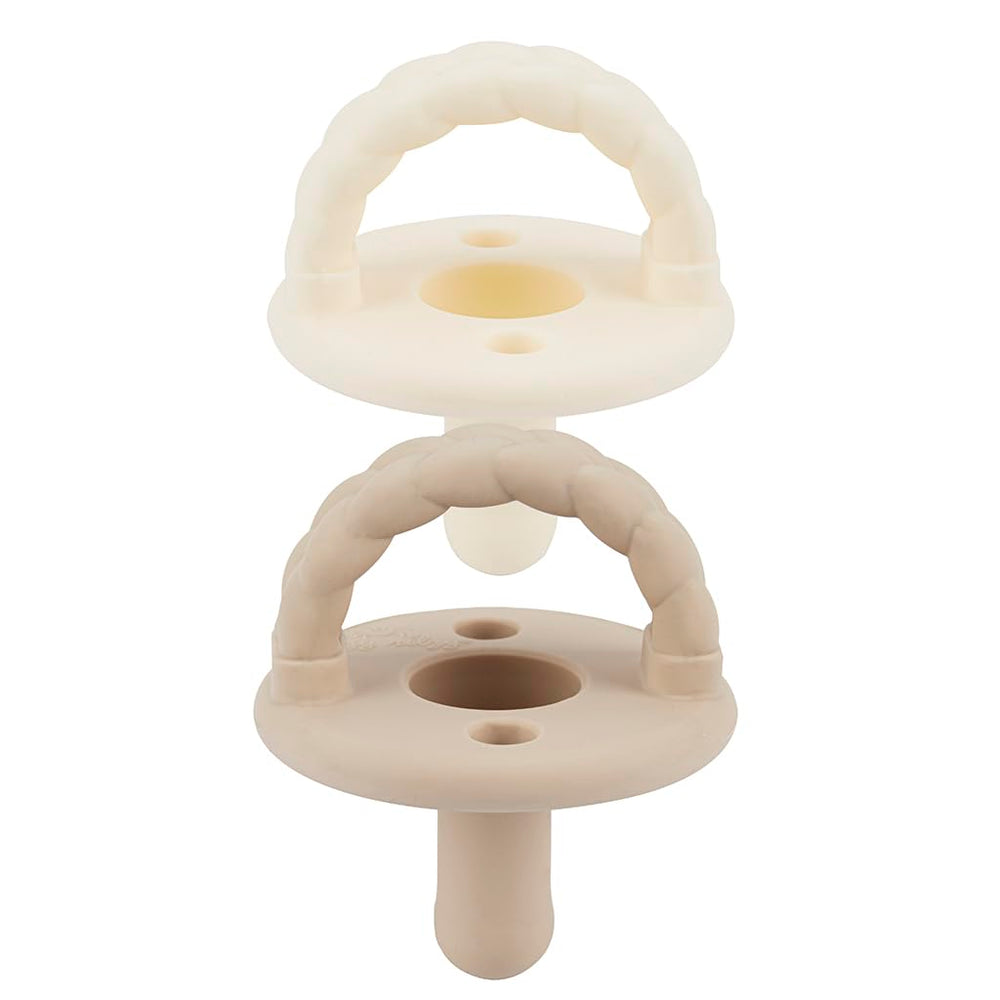 Itzy Ritzy silicone pacifier set in Buttercream and Toast for soothing comfort.