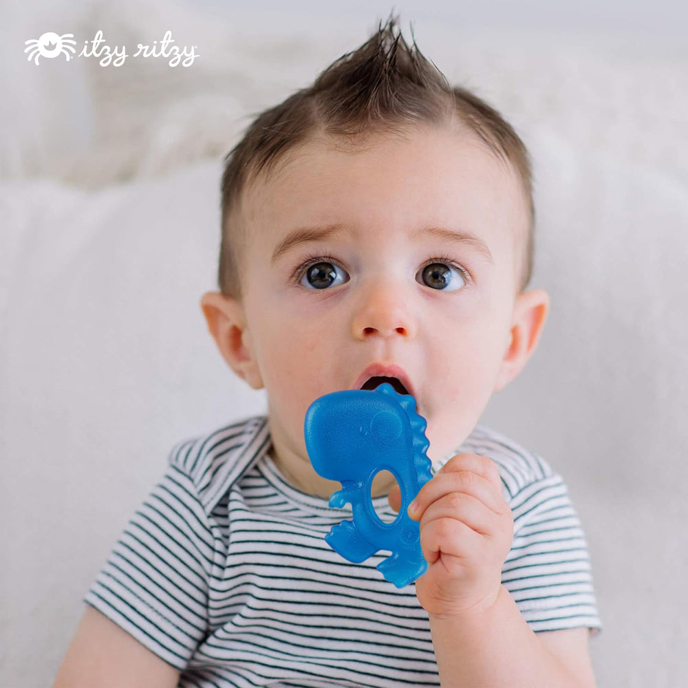 Itzy Ritzy dinosaur teether with easy grab design sits securely in tiny hands.