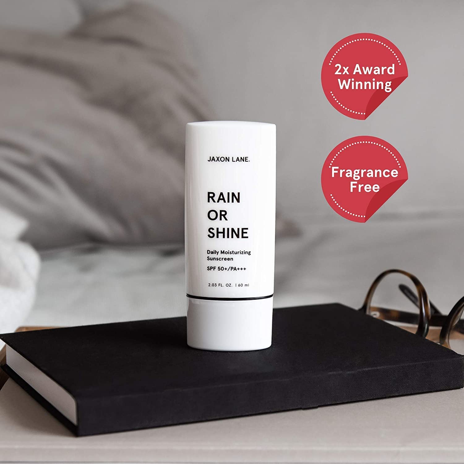 JAXON LANE Rain or Shine SPF 50 in-use application highlights quick absorption, non-greasy finish