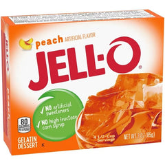 Stirring Jell-O Peach Gelatin with a spoon for smooth mixing.