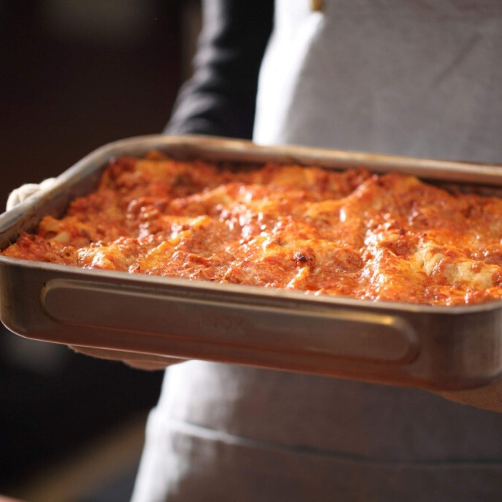 Jovial cooked al dente lasagna noodles on plate with sauce.