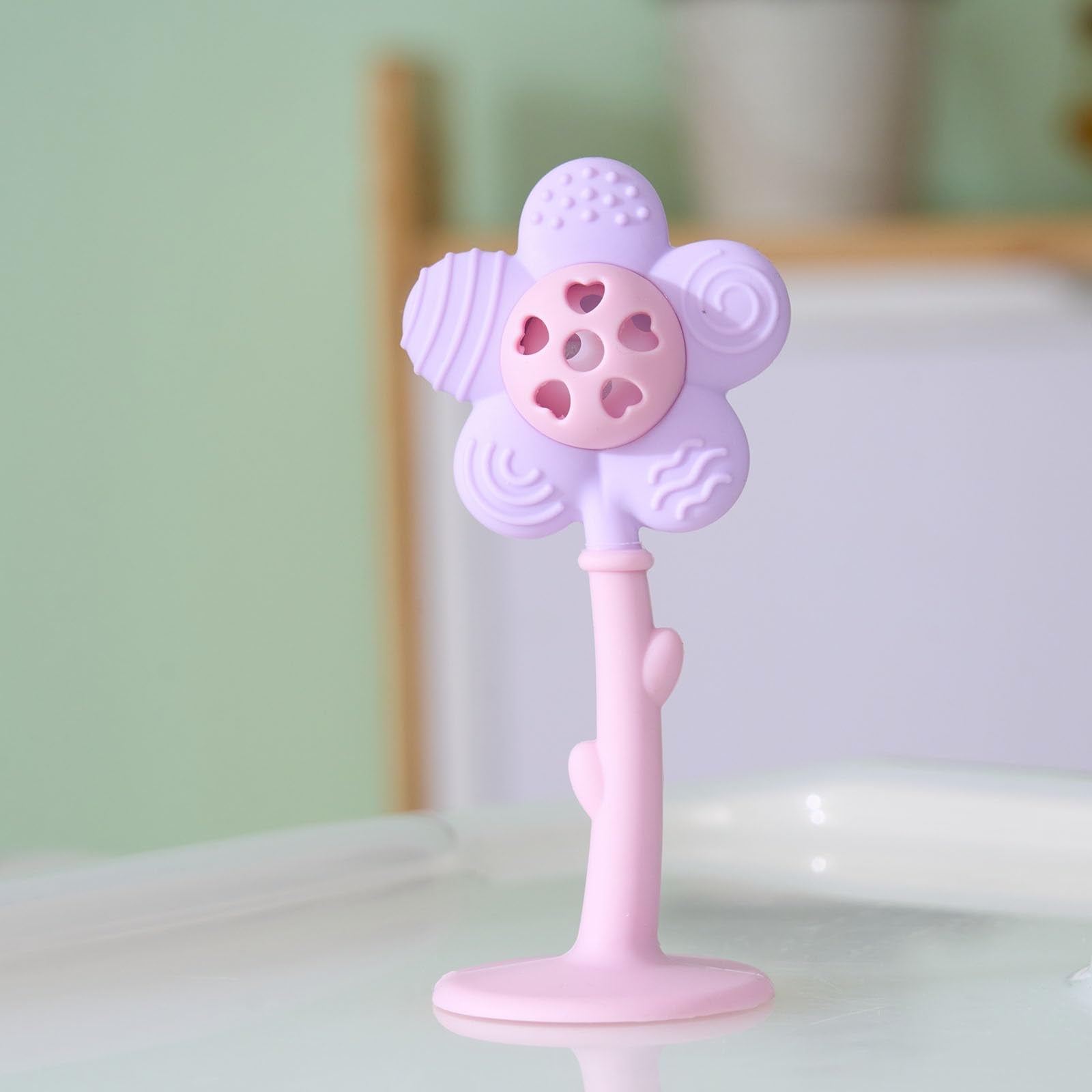 Joyfulia Sunnyflower teether in action, baby rattling for sensory engagement.