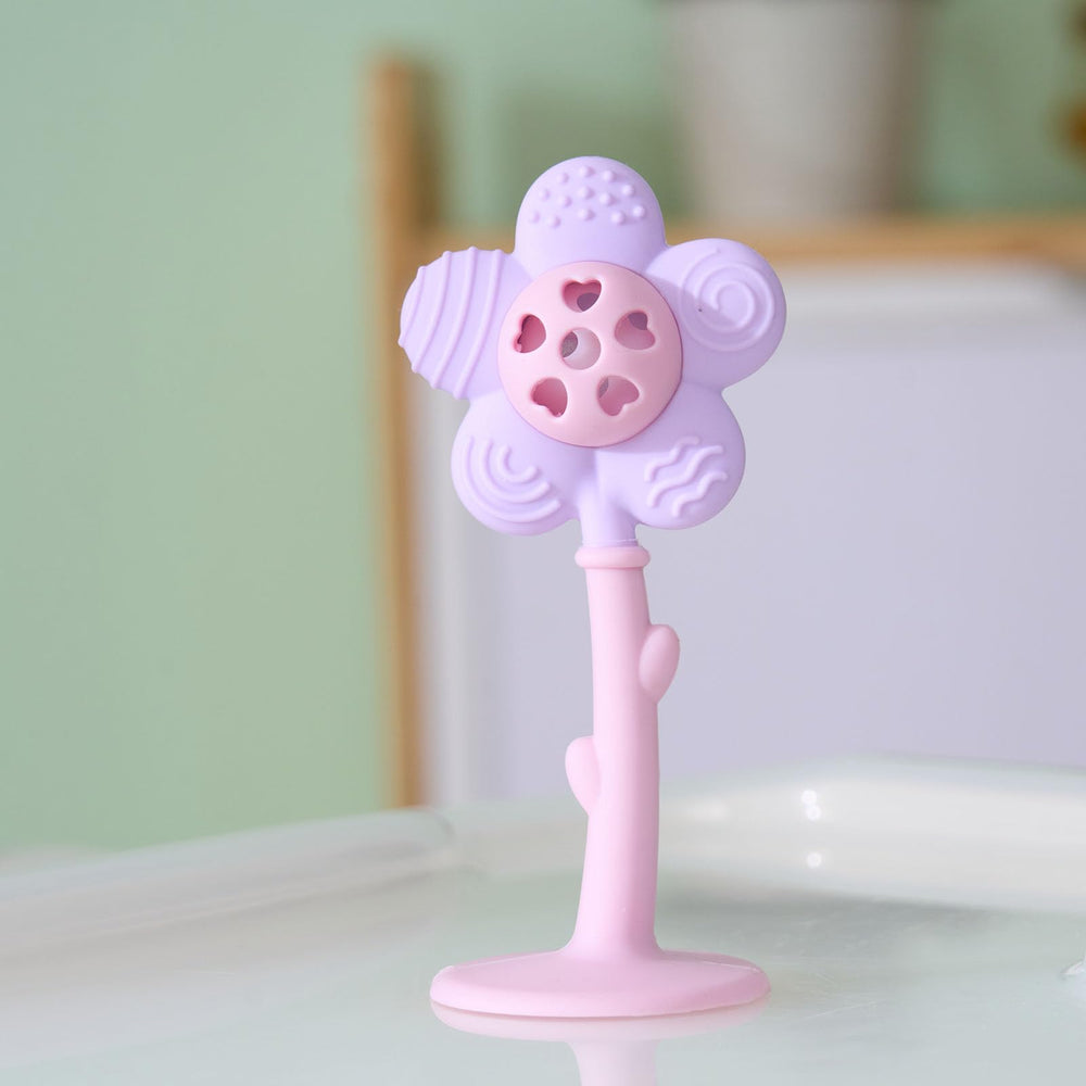 Joyfulia Sunnyflower teether in action, baby rattling for sensory engagement.