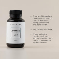 Two small JSHealth magnesium tablets shown with a meal for easy daily dose.
