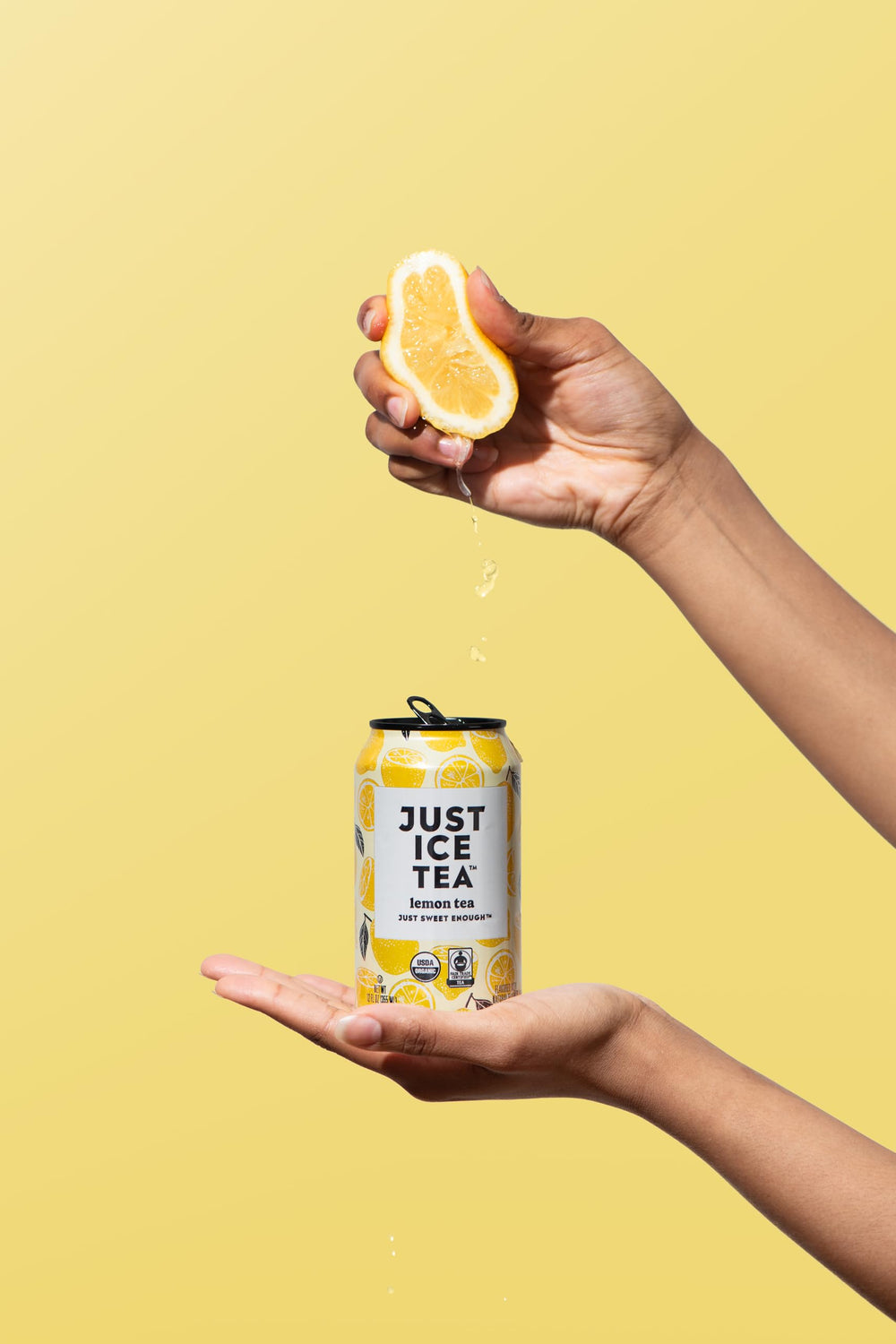 Just Ice Tea lemon-flavored black iced tea can beside a fitness bottle for workout moments