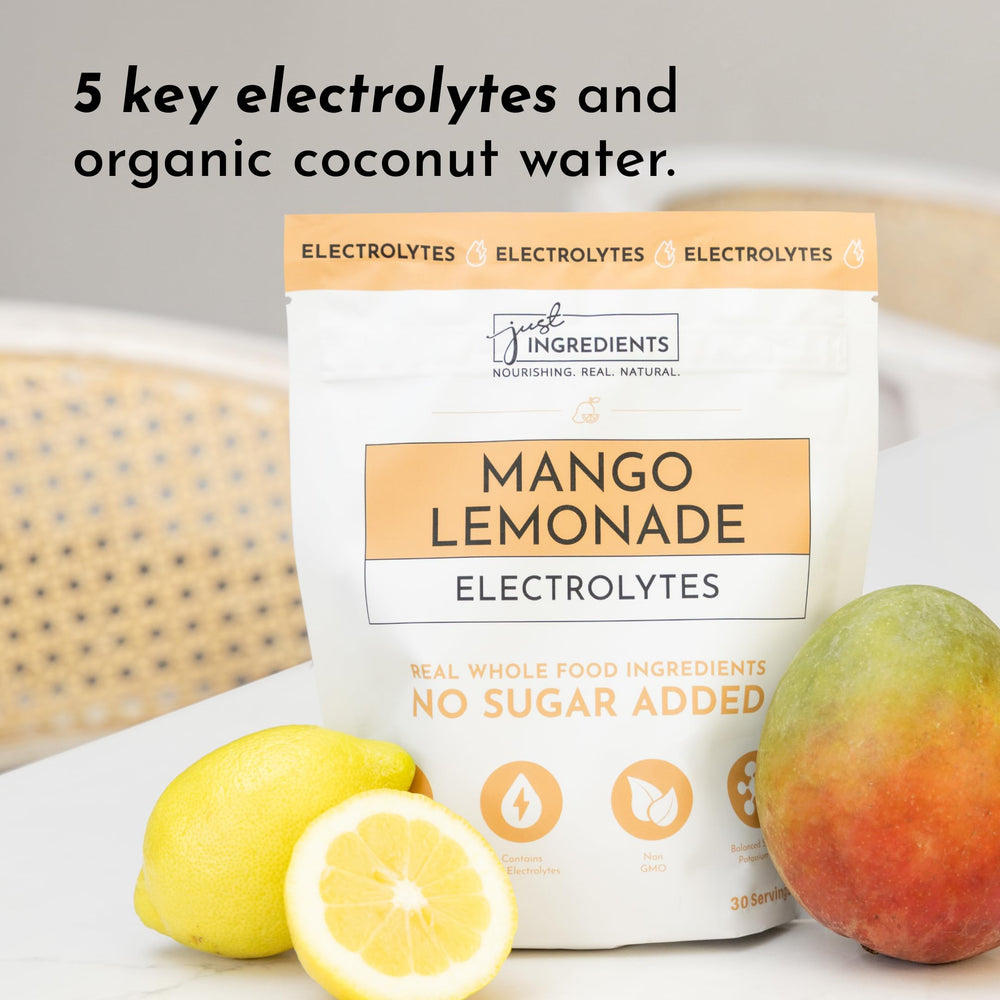 JUST INGREDIENTS Mango Lemonade electrolyte drink mix poured into a cup for quick hydration