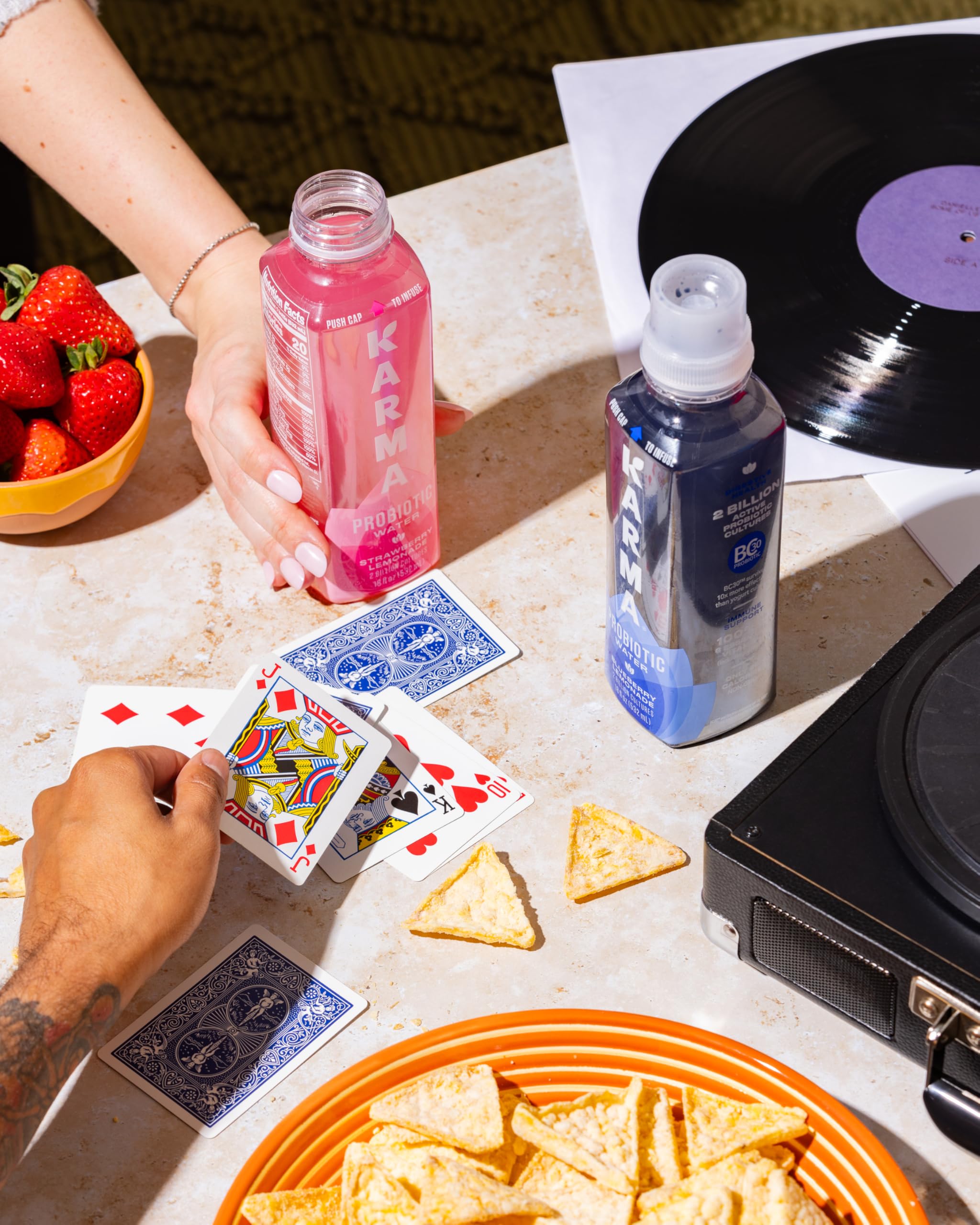 Karma Probiotic Water fruit splash emphasizes natural watermelon and wild berry tones.