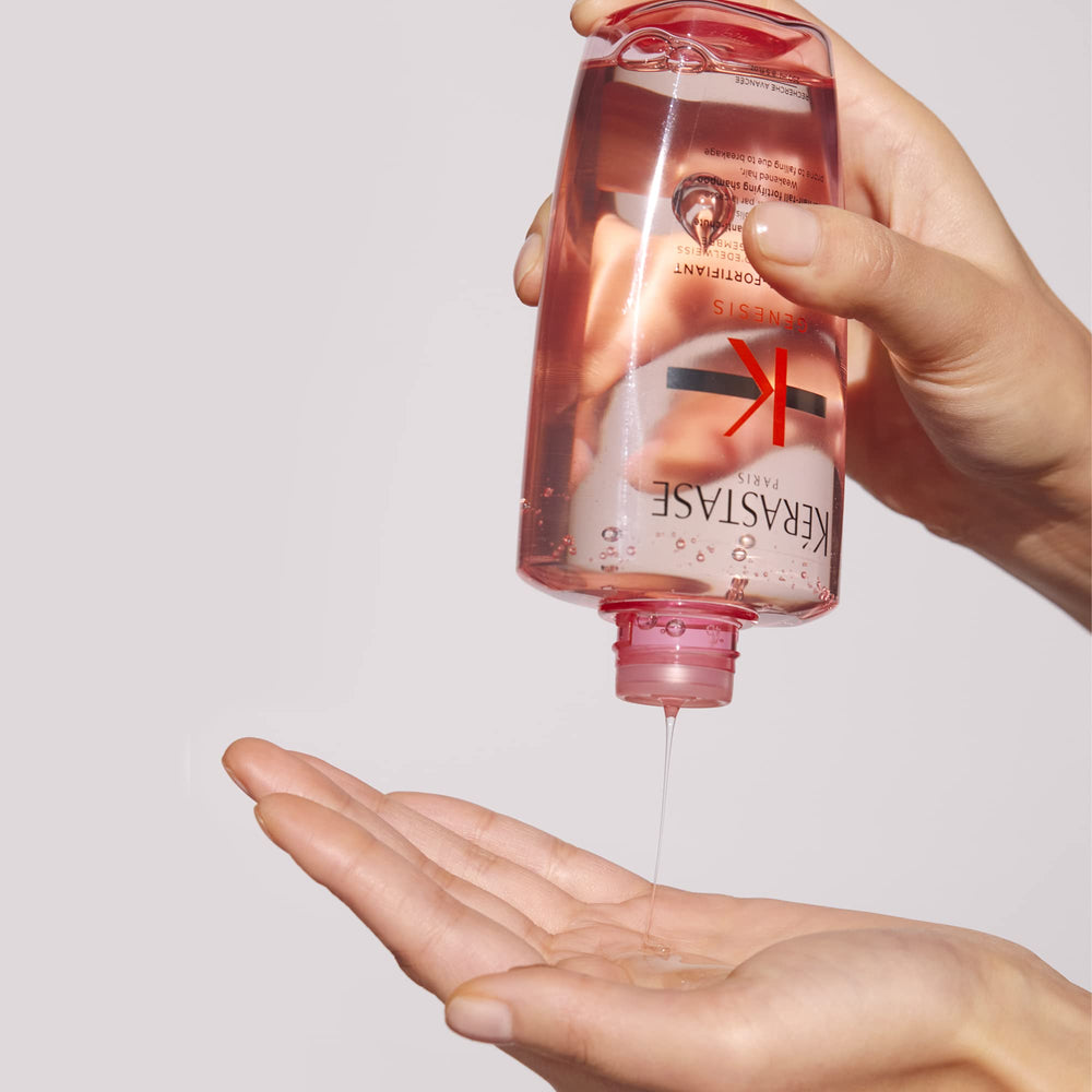 KÉRASTASE Genesis Hydra-Fortifying Shampoo foamy rinse action captured on sink.