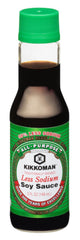 Kikkoman Less Sodium soy sauce bottles beside dipping plate for versatile use.