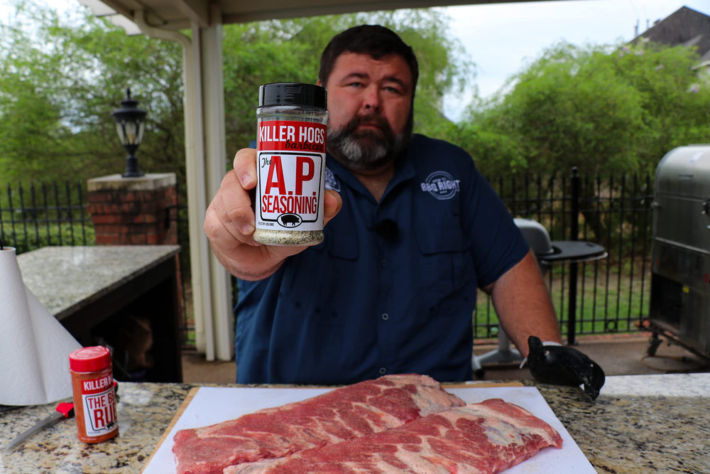 Killer Hogs AP Seasoning being poured from the shaker onto meat.
