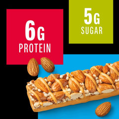 Hand holding a KIND bar showing portability for busy days.